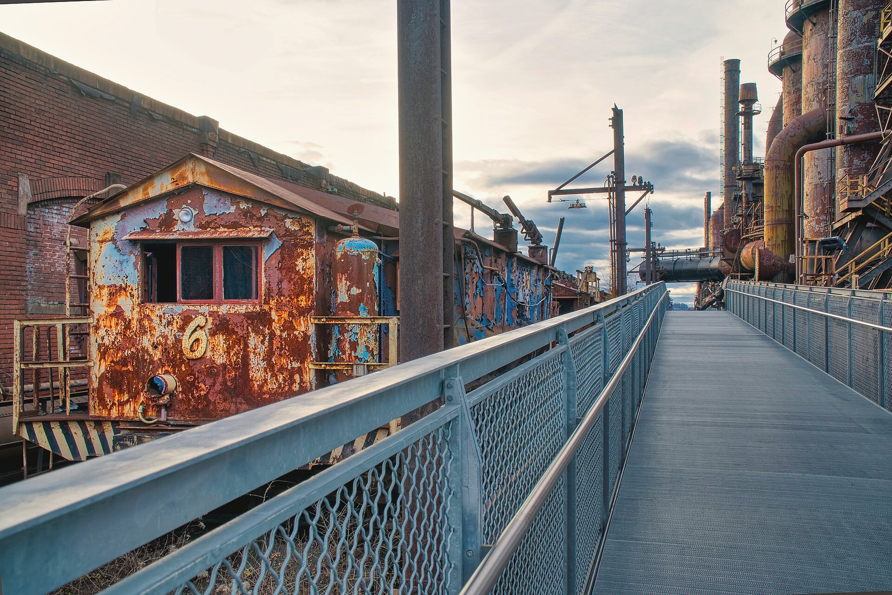 Train car on the SteelStacks campus with blast furnaces behind it